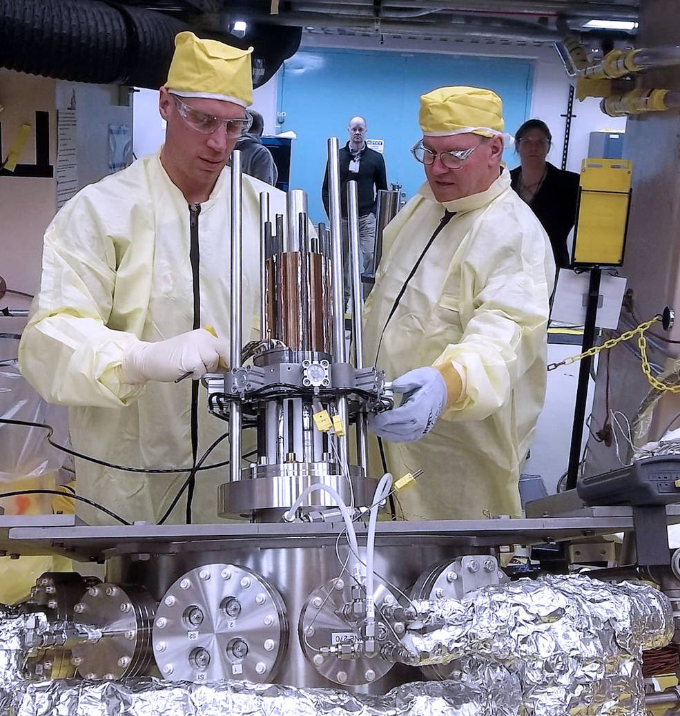 Marc Gibson, Kilopower lead engineer, and Jim Sanzi, Vantage Partners, install hardware on the Kilopower assembly at the Nevada National Security Site in March 2018<br />Credits: NNSS