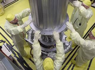 NASA and NNSA engineers lower the wall of the vacuum chamber around the Kilowatt Reactor Using Stirling TechnologY (KRUSTY system). The vacuum chamber is later evacuated to simulate the conditions of space when KRUSTY operates.<br /><br />Credits: Los Alamos National Laboratory