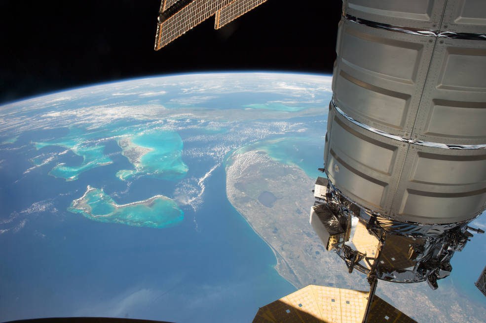 The Orbital ATK Cygnus cargo craft is pictured as the International Space Station orbits above the state of Florida, The Bahamas and the country of Cuba.<br />Credits: NASA