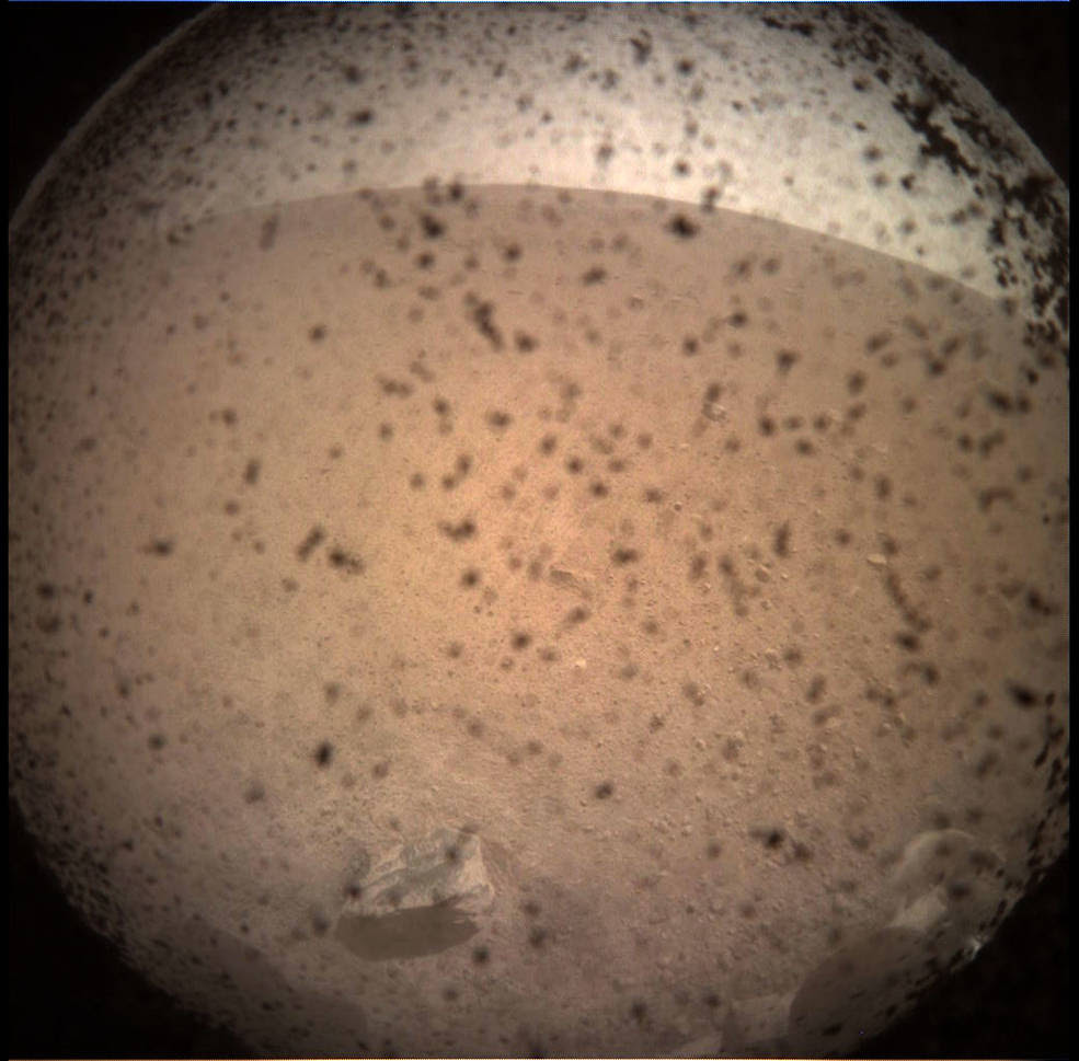 NASA's InSight Mars lander acquired this image of the area in front of the lander using its lander-mounted, Instrument Context Camera (ICC). This image was acquired on Nov. 26, 2018, Sol 0 of the InSight mission where the local mean solar time for the image exposures was 13:34:21. Each ICC image has a field of view of 124 x 124 degrees.<br />Credits: NASA/JPL-Caltech