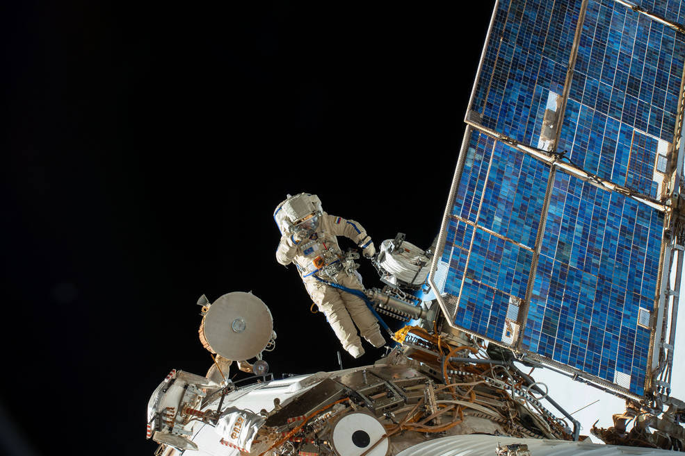 Roscosmos cosmonaut Sergey Prokopyev lays cable for the installation of the Icarus animal-tracking experiment on the Zvezda service module during a spacewalk that lasted 7 hours 46 minutes. Fellow cosmonaut Oleg Artemyev (out of frame) joined Prokopyev during the spacewalk which also saw the deployment of four nano-satellites and the retrieval of a materials exposure experiment on the Russian segment of the International Space Station.<br />Credits: NASA