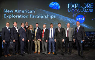 NASA Administrator Jim Bridenstine, left, and Associate Administrator for the Science Mission Directorate Thomas Zurbuchen, right, join with representatives of nine U.S. companies that are eligible to bid on NASA delivery services to the lunar surface through Commercial Lunar Payload Services contracts Thursday, Nov. 29, 2018, at NASA Headquarters in Washington.<br /><br />Credits: NASA/Bill Ingalls