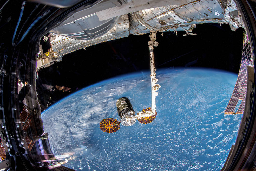 Northrop Grumman's Cygnus spacecraft, with its prominent cymbal-shaped UltraFlex solar arrays, is pictured Nov. 19, 2018, in the grips of the International Space Station's Canadarm2 robotic arm after it was captured by Expedition 57 Flight Engineer Serena Auñón-Chancellor and ESA (European Space Agency) astronaut Alexander Gerst.<br />Credits: NASA