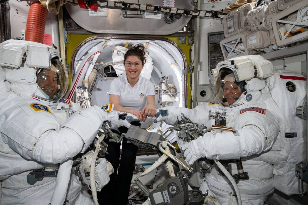 NASA astronaut Christina Koch (center) assists fellow astronauts Nick Hague (left) and Anne McClain in their U.S. spacesuits shortly before they begin the first spacewalk of their careers. Hague and McClain worked outside, in the vacuum of space, for six hours and 39 minutes on March 22, 2019, to upgrade the International Space Station's power storage capacity.<br />Credits: NASA