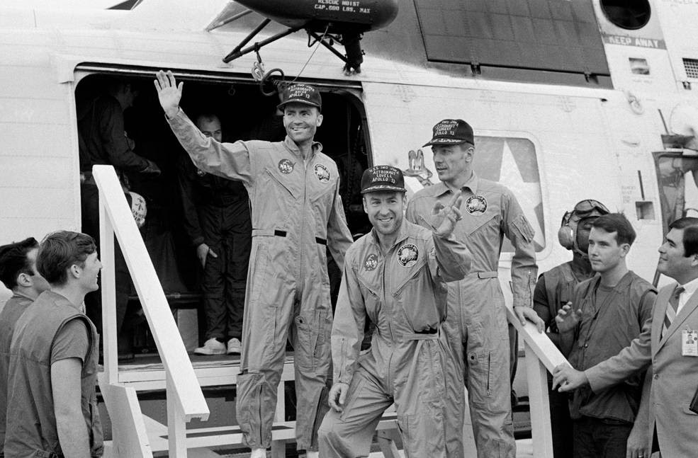 S70-35614 (17 April 1970) --- The crewmembers of the Apollo 13 mission, step aboard the USS Iwo Jima, prime recovery ship for the mission, following splashdown and recovery operations in the South Pacific Ocean. Exiting the helicopter which made the pick-up some four miles from the Iwo Jima are (from left) astronauts Fred W. Haise Jr., lunar module pilot; James A. Lovell Jr., commander; and John L. Swigert Jr., command module pilot. The crippled Apollo 13 spacecraft splashed down at 12:07:44 p.m. (CST), April 17, 1970.<br />Credits: NASA