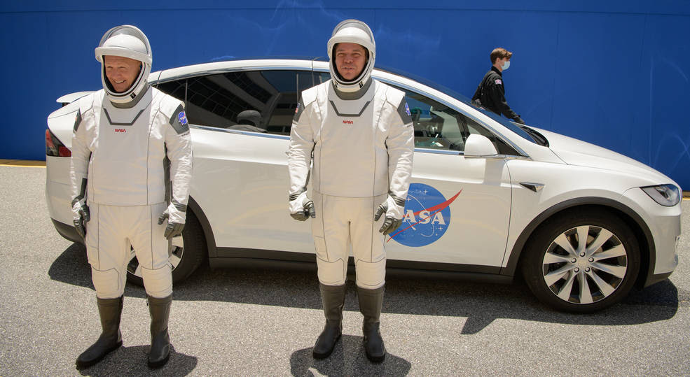 NASA astronauts Douglas Hurley, left, and Robert Behnken, wearing SpaceX spacesuits, are seen as they depart the Neil A. Armstrong Operations and Checkout Building for Launch Complex 39A during a dress rehearsal prior to the Demo-2 mission launch, Saturday, May 23, 2020.<br />Credits: NASA/ Bill Ingalls