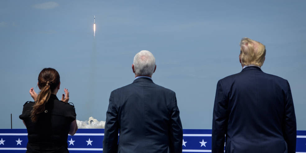 President Donald Trump, right, Vice President Mike Pence, and Second Lady Karen Pence watch the launch of a SpaceX Falcon 9 rocket carrying the company's Crew Dragon spacecraft on NASA’s SpaceX Demo-2 mission with NASA astronauts Robert Behnken and Douglas Hurley onboard, Saturday, May 30, 2020, from the balcony of Operations Support Building II at NASA’s Kennedy Space Center in Florida. NASA’s SpaceX Demo-2 mission is the first launch with astronauts of the SpaceX Crew Dragon spacecraft and Falcon 9 rocket to the International Space Station as part of the agency’s Commercial Crew Program. The test flight serves as an end-to-end demonstration of SpaceX’s crew transportation system. Behnken and Hurley launched at 3:22 p.m. EDT on Saturday, May 30, from Launch Complex 39A at the Kennedy Space Center. A new era of human spaceflight is set to begin as American astronauts once again launch on an American rocket from American soil to low-Earth orbit for the first time since the conclusion of the Space Shuttle Program in 2011.<br />Credits: NASA/Bill Ingalls