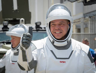 NASA astronauts Robert Behnken, foreground, and Douglas Hurley, wearing SpaceX spacesuits, are seen as they depart the Neil A. Armstrong Operations and Checkout Building for Launch Complex 39A to board the SpaceX Crew Dragon spacecraft for the Demo-2 mission launch, Saturday, May 30, 2020, at NASA’s Kennedy Space Center in Florida. NASA’s SpaceX Demo-2 mission is the first launch with astronauts of the SpaceX Crew Dragon spacecraft and Falcon 9 rocket to the International Space Station as part of the agency’s Commercial Crew Program. The test flight serves as an end-to-end demonstration of SpaceX’s crew ransportation system. Behnken and Hurley are scheduled to launch at 3:22 p.m. EDT on Saturday, May 30, from Launch Complex 39A at the Kennedy Space Center. A new era of human spaceflight is set to begin as American astronauts once again launch on an American rocket from American soil to low-Earth orbit for the first time since the conclusion of the Space Shuttle Program in 2011.<br /><br />Credits: NASA/Bill Ingalls