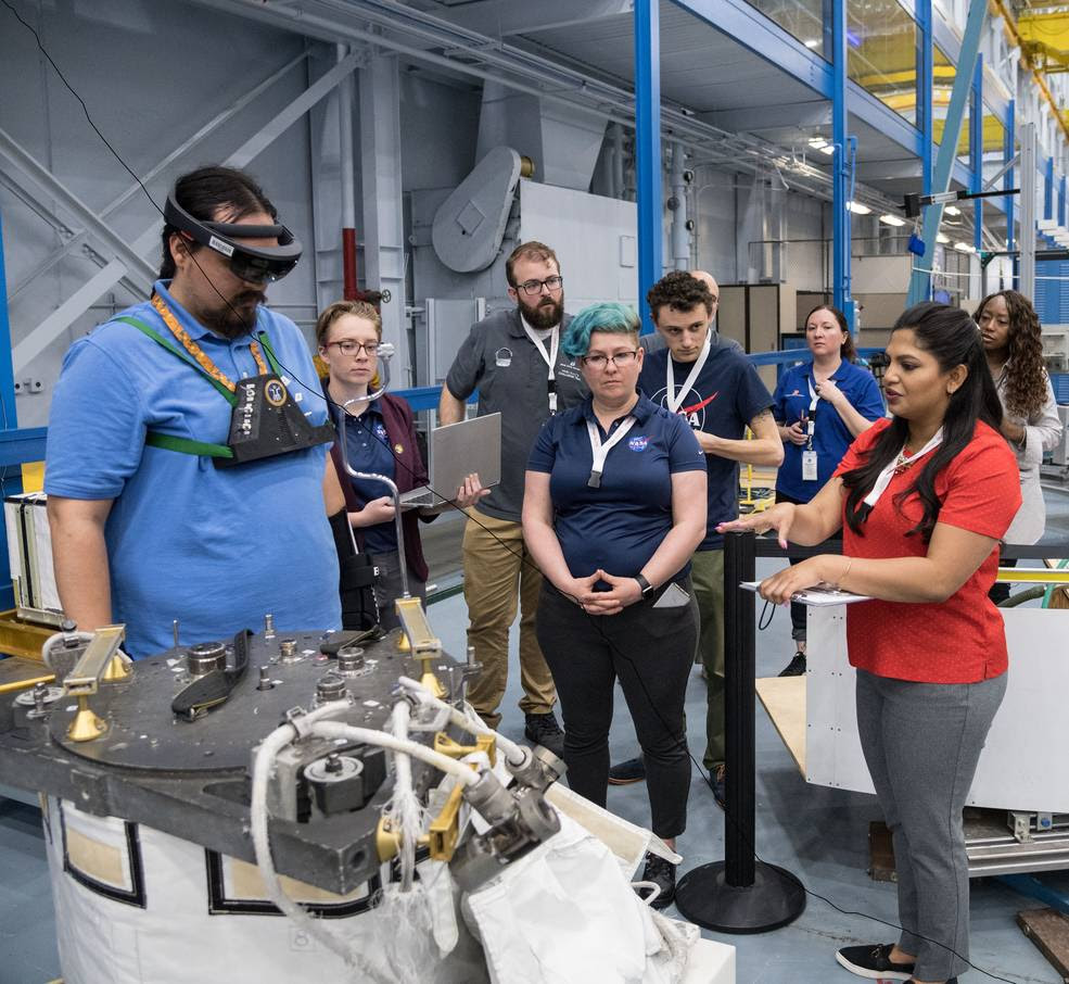 NASA engineers conducting a design evaluation with user interface heads up display software designed by participants of the NASA SUITS challenge.<br />Credits: NASA